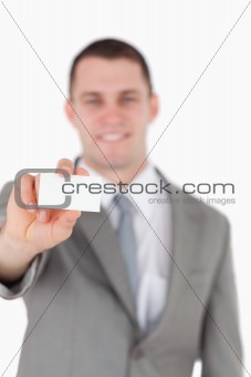 Portrait of a businessman showing a blank business card