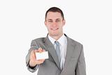 Smiling businessman showing a blank business card