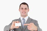 Young businessman pointing at a blank business card