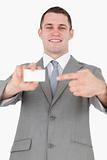Portrait of a businessman pointing at a blank business card