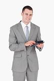 Portrait of a smiling businessman working with a calculator