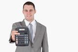 Businessman showing a calculator