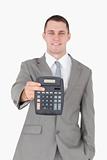 Portrait of a businessman showing a calculator