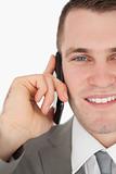 Close up of a smiling businessman making a phone call