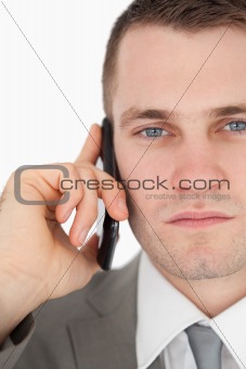 Close up of a serious businessman making a phone call
