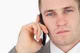 Close up of a focused businessman making a phone call