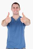 Portrait of a young man with the thumbs up