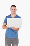 Portrait of a man holding a laptop
