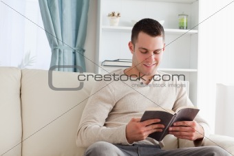 Handsome man reading a book
