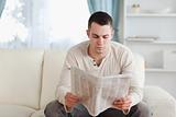 Serious man reading a newspaper