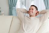 Laughing man relaxing on a sofa