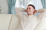 Laughing man relaxing on a couch