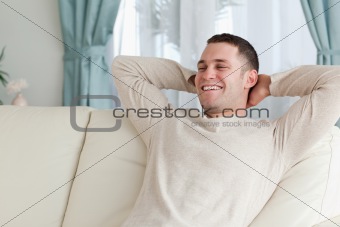 Laughing man relaxing on a couch
