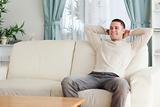Happy man relaxing on a couch