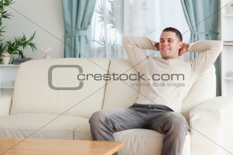 Happy man relaxing on a couch