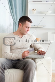 Portrait of a young man shopping online