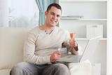 Happy man shopping online with the thumb up