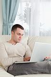 Portrait of a man relaxing with a laptop