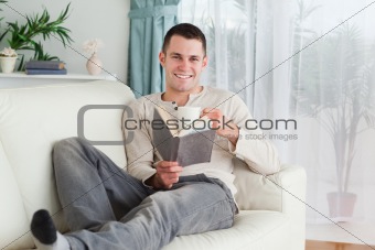 Happy man reading a book