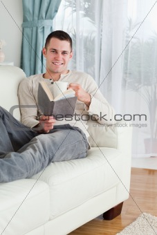 Portrait of a happy man reading a book