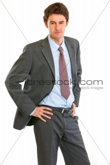 Angry modern businessman with hand on hips
