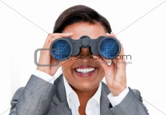 Assertive businesswoman looking through binoculars