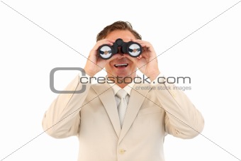 Smiling businessman looking through binoculars 
