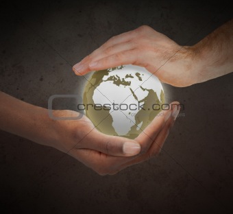 Hands protecting a glowing planet globe