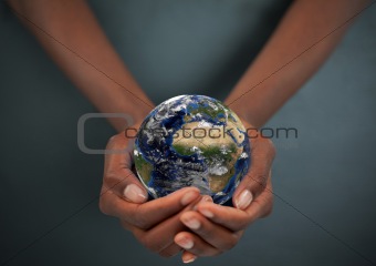 Feminine hands holding the Earth