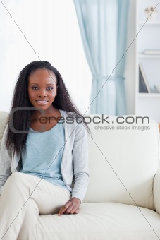 Young woman sitting on sofa