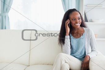 Woman phoning on sofa