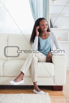 Woman with cellphone on sofa