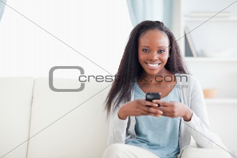 Woman in living room with her phone