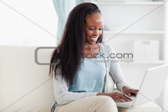 Woman on sofa working on laptop