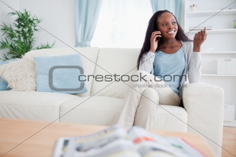 Woman with smartphone on sofa