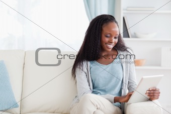 Woman using tablet on sofa