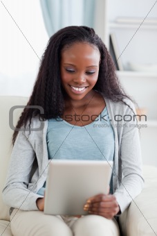 Close up of woman with her tablet on sofa