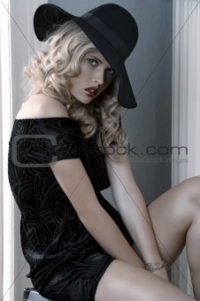 elegant dressed girl posing with a hat