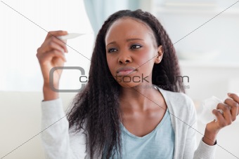 Close up of woman measuring her temperature