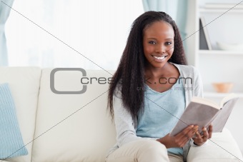 Woman reading a book on sofa