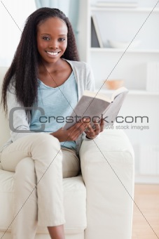 Woman reading a book on couch