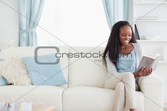 Woman reading a book in living room