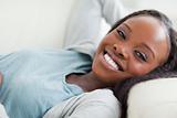 Close up of smiling woman taking a rest on the sofa