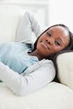 Close up of happy woman taking a rest on the sofa