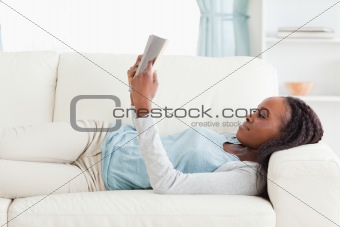 Woman on sofa reading a novel