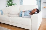 Woman on sofa listening to music