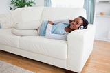 Woman on couch listening to music