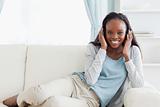 Woman relaxing on sofa with headphones on