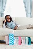 Woman relaxing on sofa after shopping