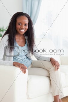 Woman on sofa with legs folded